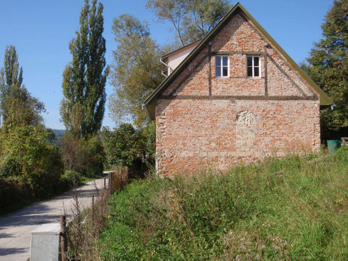 A brick home, with a bricked in window.